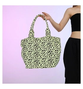 Detailed side view of large leopard print tote bag with soft double handles for daily use