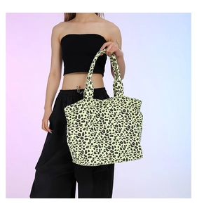 Asian model holding a neon leopard print tote bag against a pastel gradient background