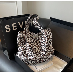 Detailed view of fashionable leopard print tote bag placed inside a premium black gift box