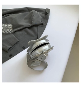 Detailed top view of a silver cat-shaped crossbody bag with a metallic finish and zipper