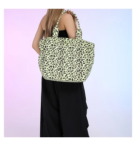 Large leopard print canvas tote bag shown on shoulder for daily commute and leisure use