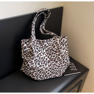 Macro detail of high-quality leopard print canvas fabric on this large tote bag
