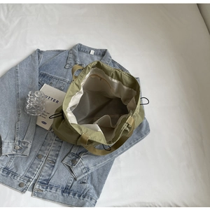 Detail view of large canvas tote bag interior with compartments and drawstring detail