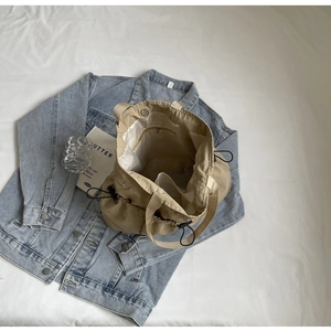 Top view of khaki canvas tote bag showing magnetic closure and interior zipper pocket