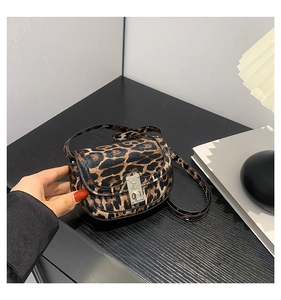 Close-up of leopard print baguette bag featuring silver metal buckle and slim shoulder strap