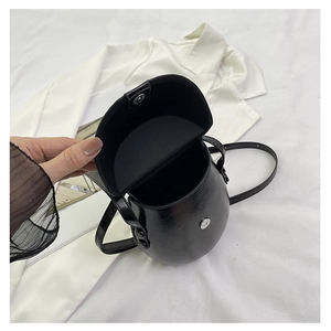 Close-up of black glossy saddle bag featuring magnetic closure and premium lining