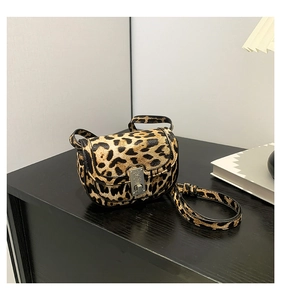 Close-up of leopard print shoulder bag with metallic buckle and leather texture
