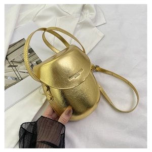 Close-up of golden saddle bag with cracked texture and Fashion & Bags text on cover