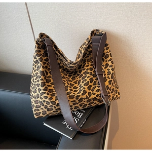 Detail of the leopard print canvas tote bag with premium brown leather strap and stitching