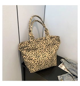 Detail of leopard print tote bag showing the thick canvas texture and sturdy top handles