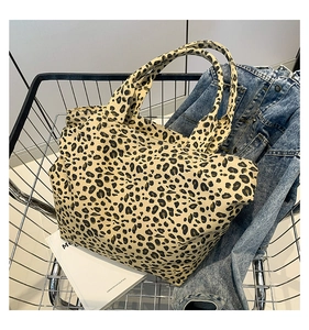Close-up of leopard print canvas tote bag inside a metal shopping basket in a lifestyle setting
