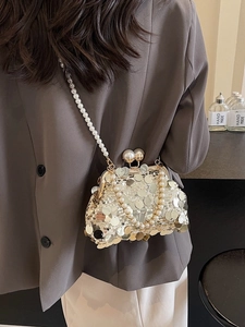 Elegant gold sequin crossbody bag with pearl chain strap and double pearl clasp detail