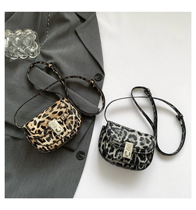 Close-up of leopard print mini bags with premium suede texture and metal twist locks
