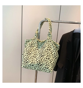 Detail of leopard print tote bag made of soft canvas material with dual top handles