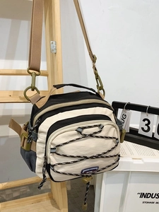 Minimalist crossbody tote bag with adjustable shoulder strap and elastic cord details