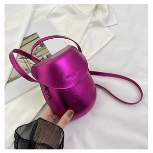 Detail of metallic purple saddle bag with embossed fashion text and pebble texture