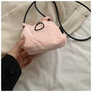 Detail of pink nylon mini crossbody bag with drawstring closure and ripstop texture