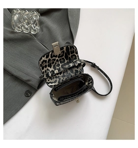 Detail of leopard print crossbody bag showing interior lining and zipper pocket