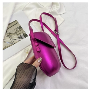 Close-up of metallic purple saddle mini bag with rivets and adjustable strap detail
