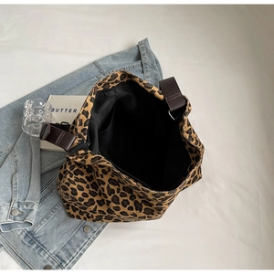 Interior view of the leopard print canvas tote bag showing the zipper pocket and black lining