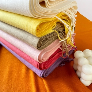 Soft faux cashmere scarf stack in vibrant colors with fringe details and warm texture