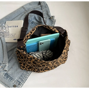 Interior view of large leopard print canvas tote bag showing storage for daily essentials