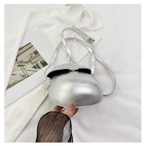 Macro detail of the silver metallic semi-circular saddle bag with glossy patent finish