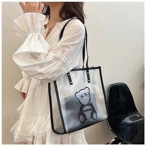 Detailed shot of transparent swim tote with black leather trim and cartoon bear design