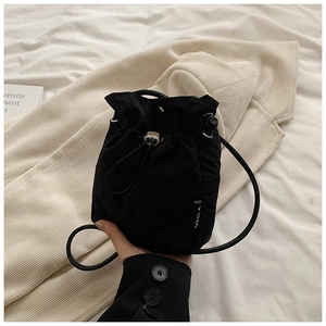 Detail of black nylon mini drawstring bucket bag with white VEILA lettering print