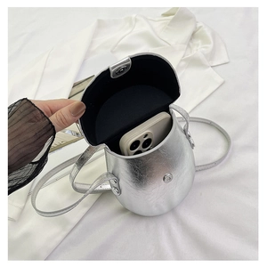 Detailed interior view of silver metallic saddle bag showing space for a smartphone