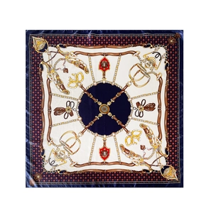 Detail of satin silk square scarf with classic gold chain and equestrian belt prints