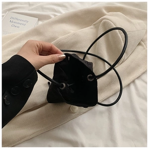 Detail view of mini nylon bucket bag interior with drawstring and silver metal eyelets