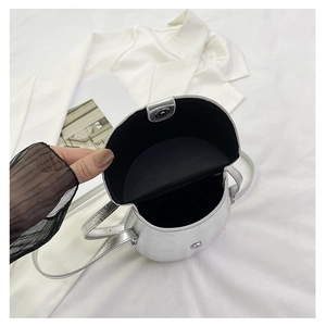 Interior view of silver saddle bag showing internal capacity and smooth black lining