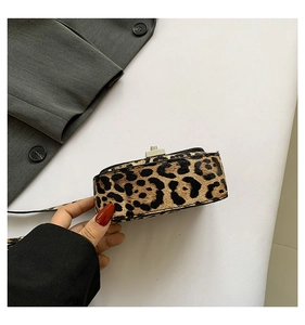 Close-up of leopard print handbag with silver twist lock and premium texture detail