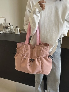 Pink pleated nylon tote bag with multi-pocket design for commute and campus life