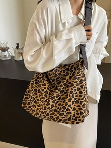 Large leopard print canvas tote bag with adjustable brown leather shoulder strap