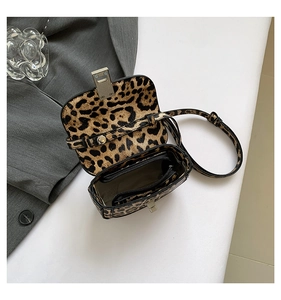 Detail view of leopard print crossbody bag showing interior lining and metal lock