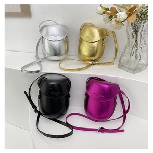 Four different colors of egg-shaped crossbody saddle bags shown on a white display stand