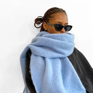 Detail showing the fluffy light blue mohair texture and soft finish of the scarf