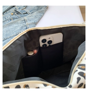 Leopard print tote bag interior featuring two slip pockets for phone and lipstick