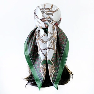 Detail showing elegant satin square scarf with classic horse bits and chain print on head