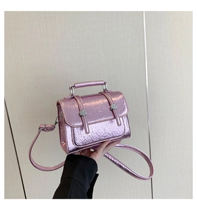 Detail of metallic purple crossbody bag featuring cracked texture and silver buckles