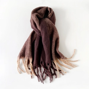 Detailed close-up of gradient mohair scarf texture with soft fringes and fuzzy knit finish