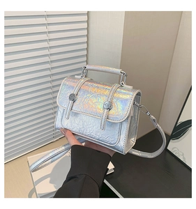 Detail of silver laser leather handbag with crackle texture and iridescent finish