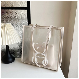 Macro view of transparent waterproof tote bag with cartoon bear print and beige trim