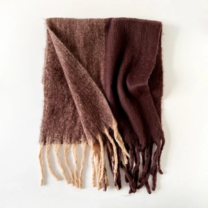 Detailed view of dual-color mohair scarf with dark coffee tones and long fringe tassels