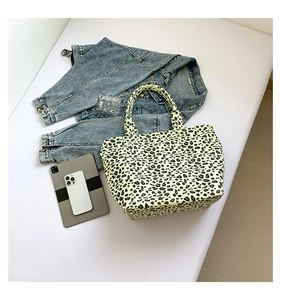 Chic leopard print canvas tote bag with yellow background and black spots lifestyle view