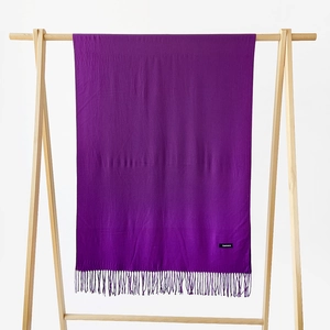 Detail view of solid dark purple cashmere scarf featuring soft texture and classic fringe edges