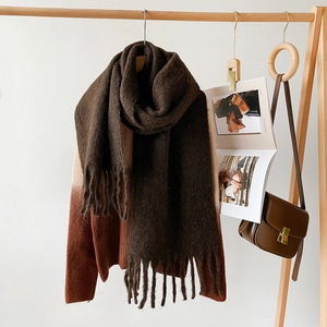 Detail view of coffee brown mohair scarf with soft texture and long tassels