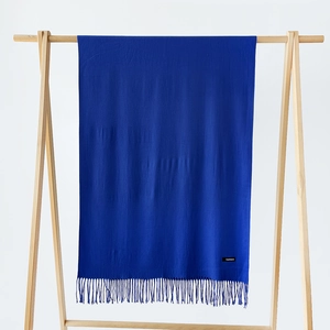 Detailed view of navy blue cashmere scarf featuring soft texture and tassel edge detail